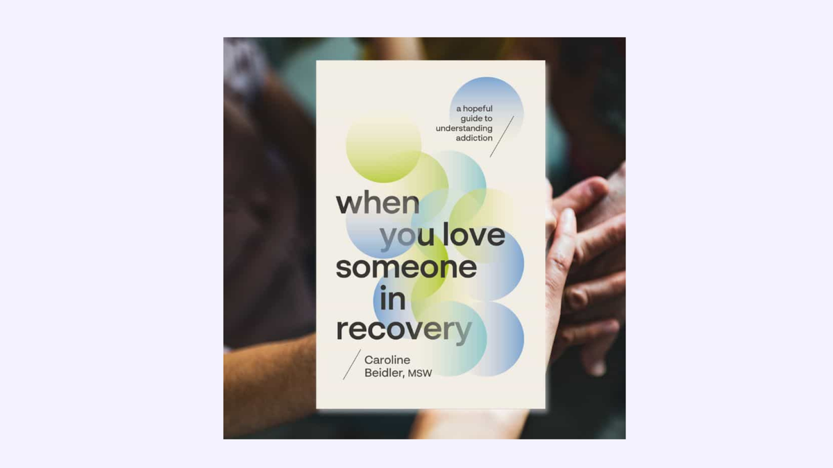 Book cover titled “When You Love Someone in Recovery” by Caroline Beidler, MSW, over a blurred background of two people holding hands.