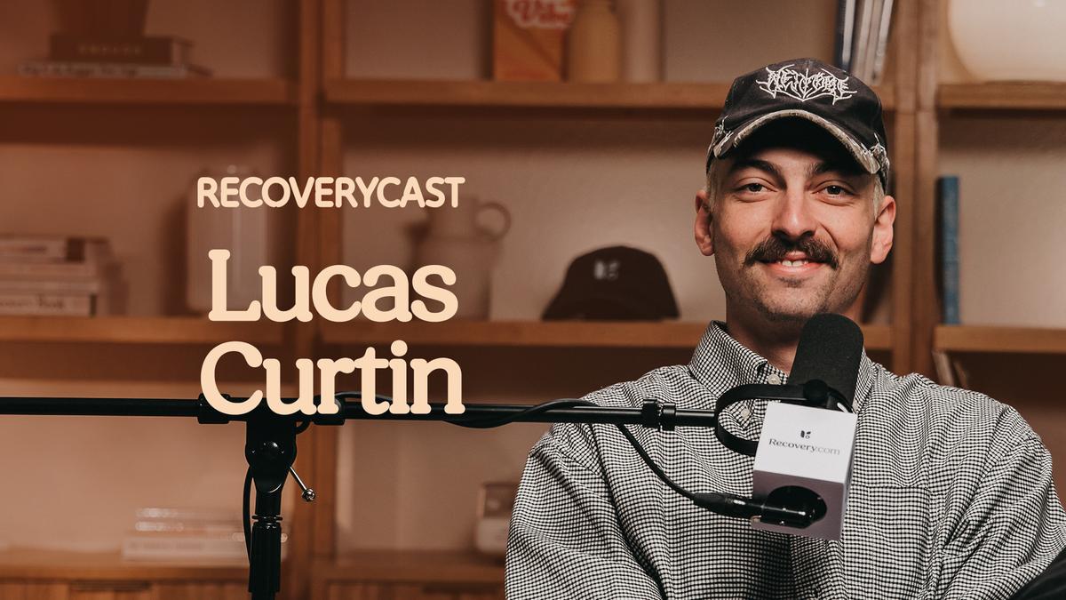 Recoverycast podcast episode featuring guest Lucas Curtin speaking into a microphone, seated in a studio with shelves in the background.