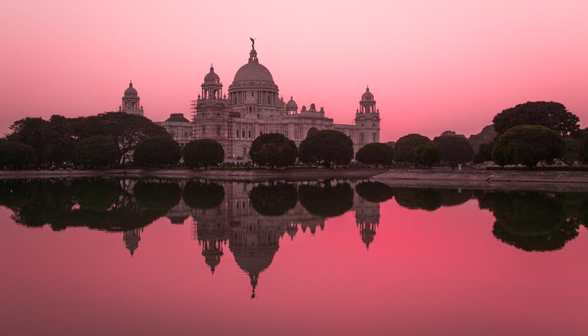 Peaceful sunset view of Kolkata landmark with water reflection, illustrating India's serene atmosphere for holistic addiction recovery