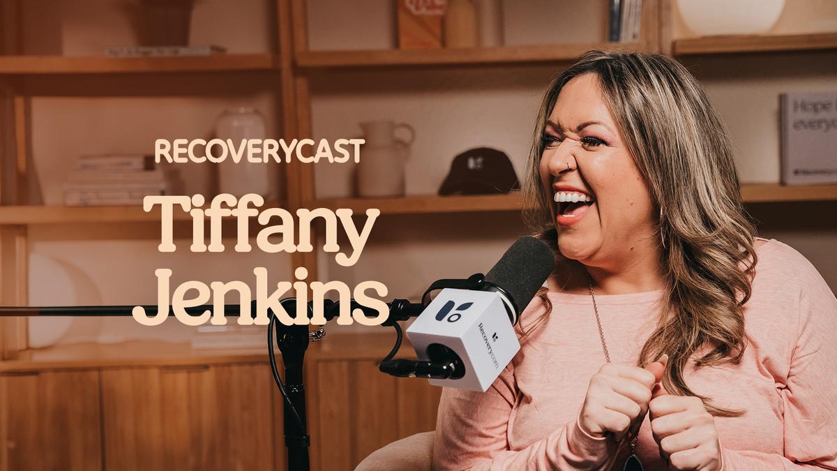 Tiffany Jenkins laughing while speaking into a podcast microphone during a “Recoverycast” interview.