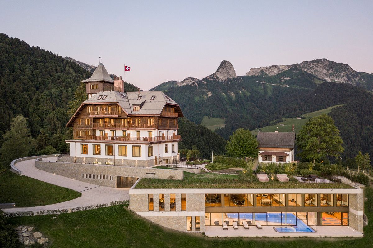 Luxury rehab center in Swiss Alps featuring traditional chalet architecture with modern spa facilities and mountain views