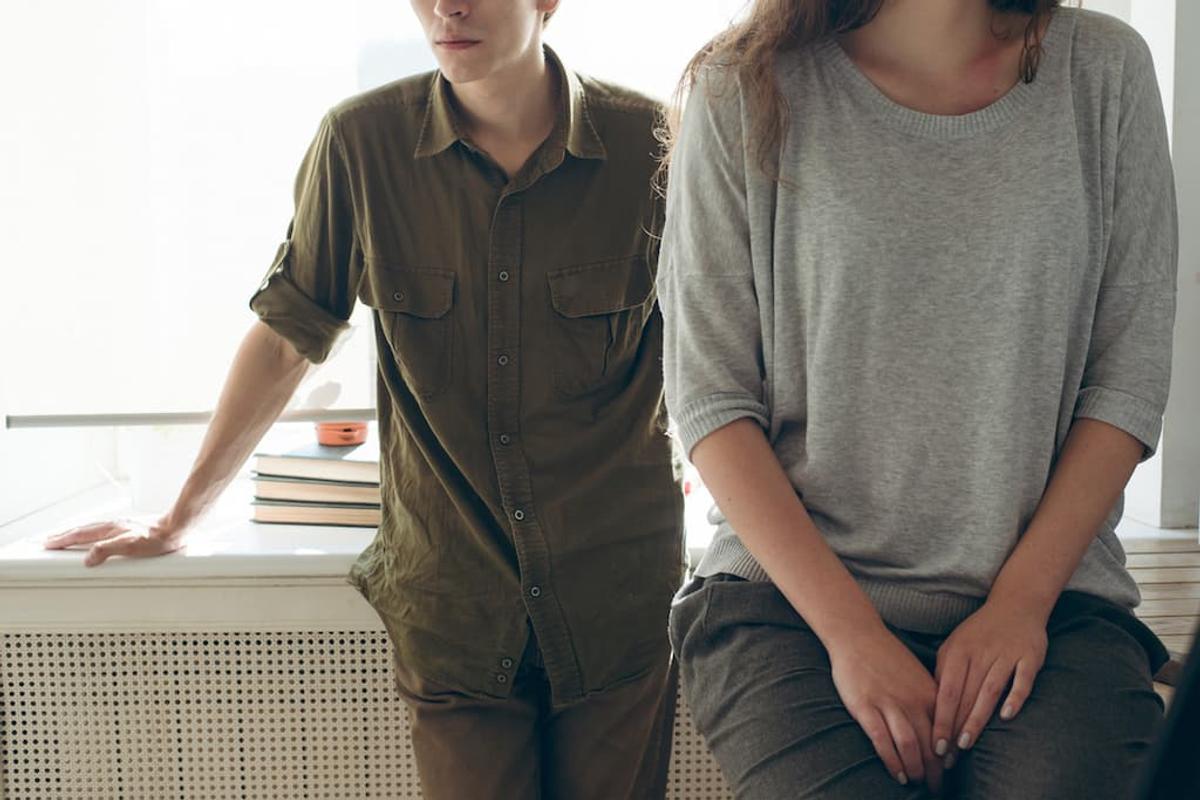 A close-up, cropped image of a young man and woman. 