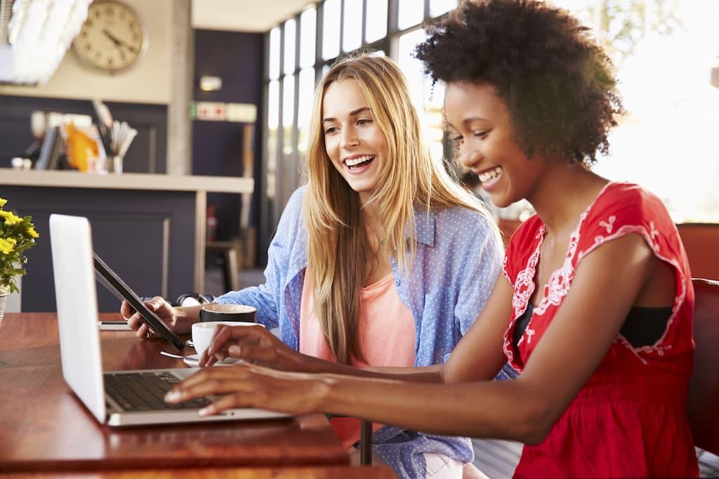 Two women collaborating on leadership project in professional workplace