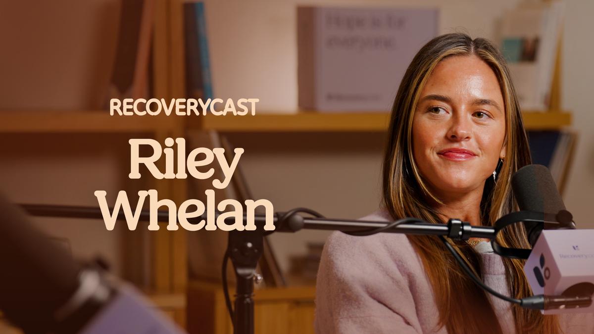 Recoverycast podcast recording featuring Riley Whelan speaking into a microphone in a warm studio setting, with her name displayed on screen.