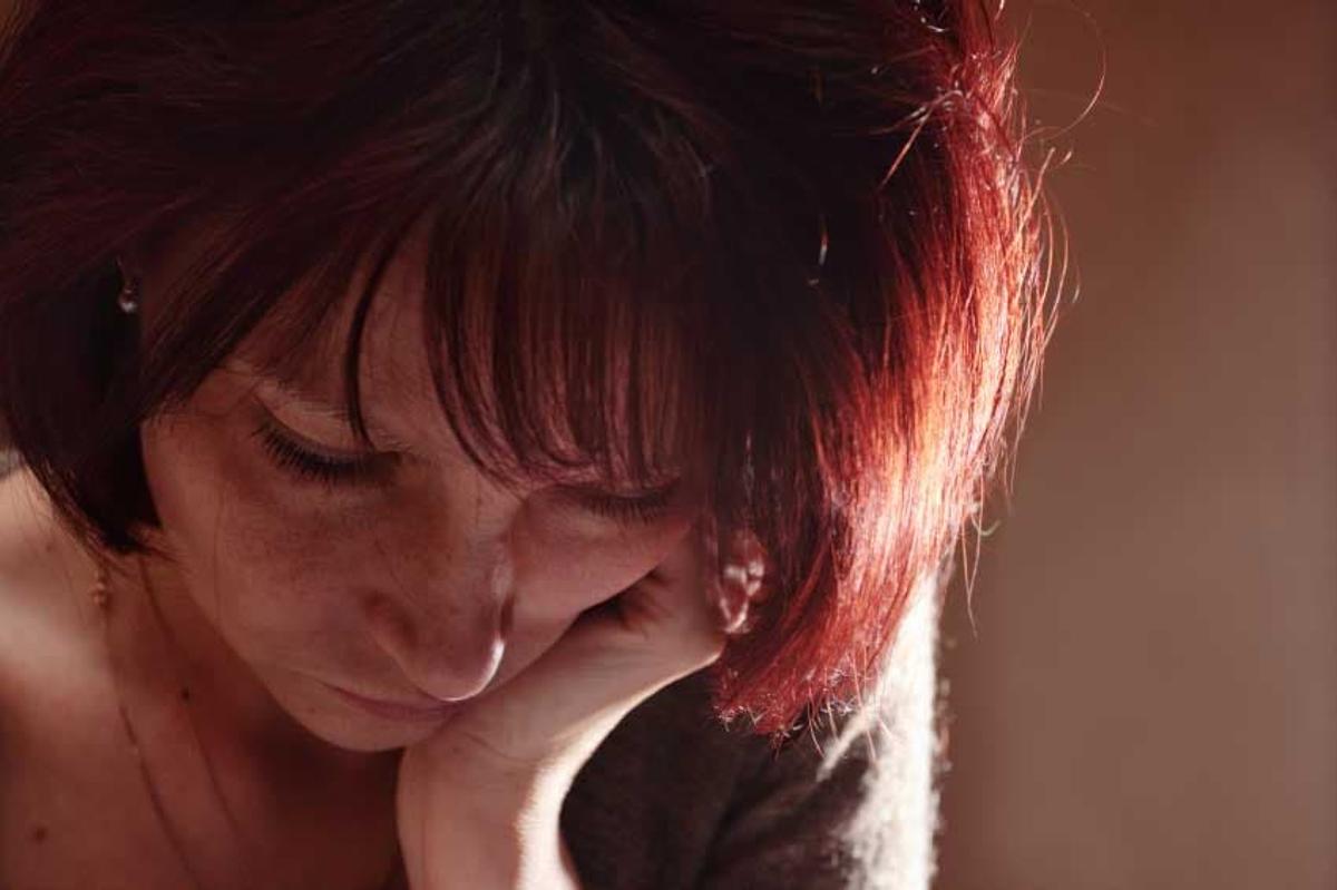 Young woman experiencing grief and emotional pain during addiction recovery