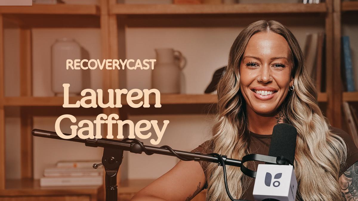 Lauren Gaffney smiles while speaking into a microphone during an episode of Recoverycast.
