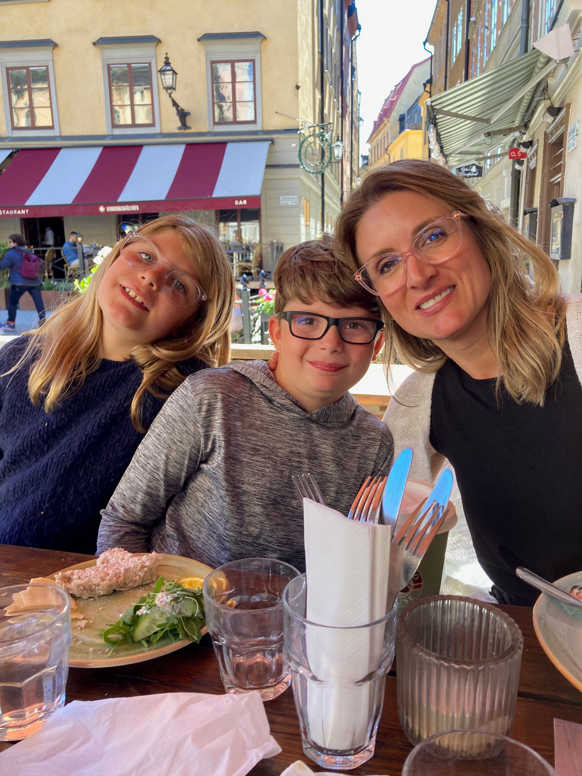 Caroline Beidler enjoys an outdoor meal with her two children during a family trip.