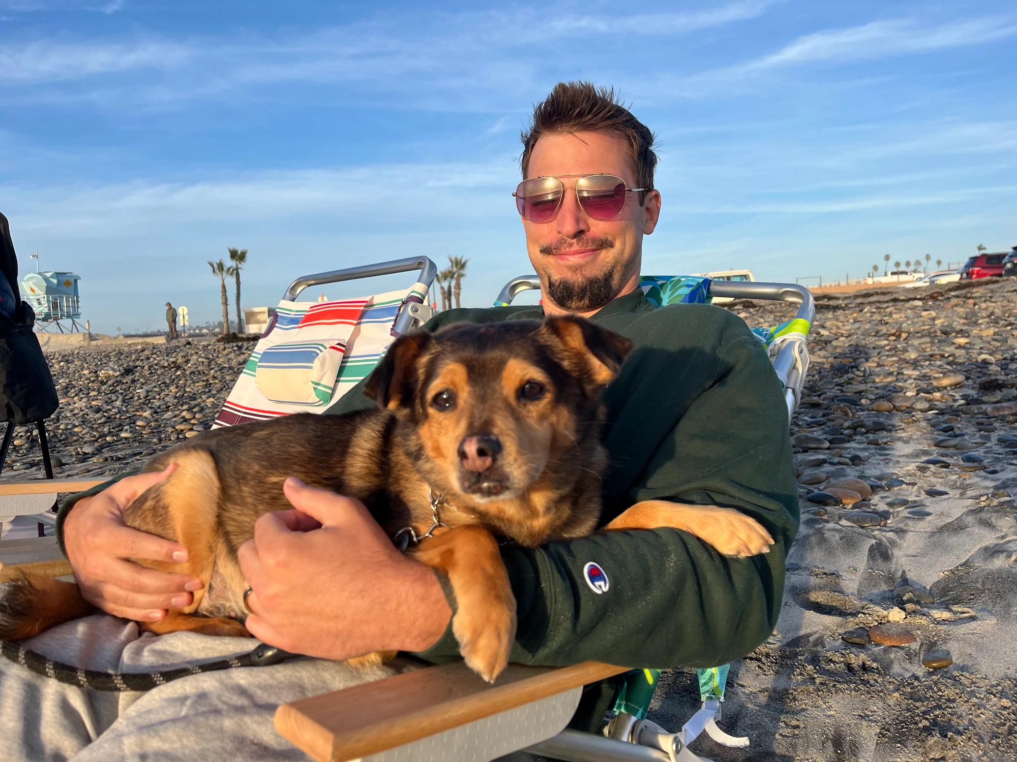 Clint Mally relaxing on his favorite beach in San Diego with his dog Olibo