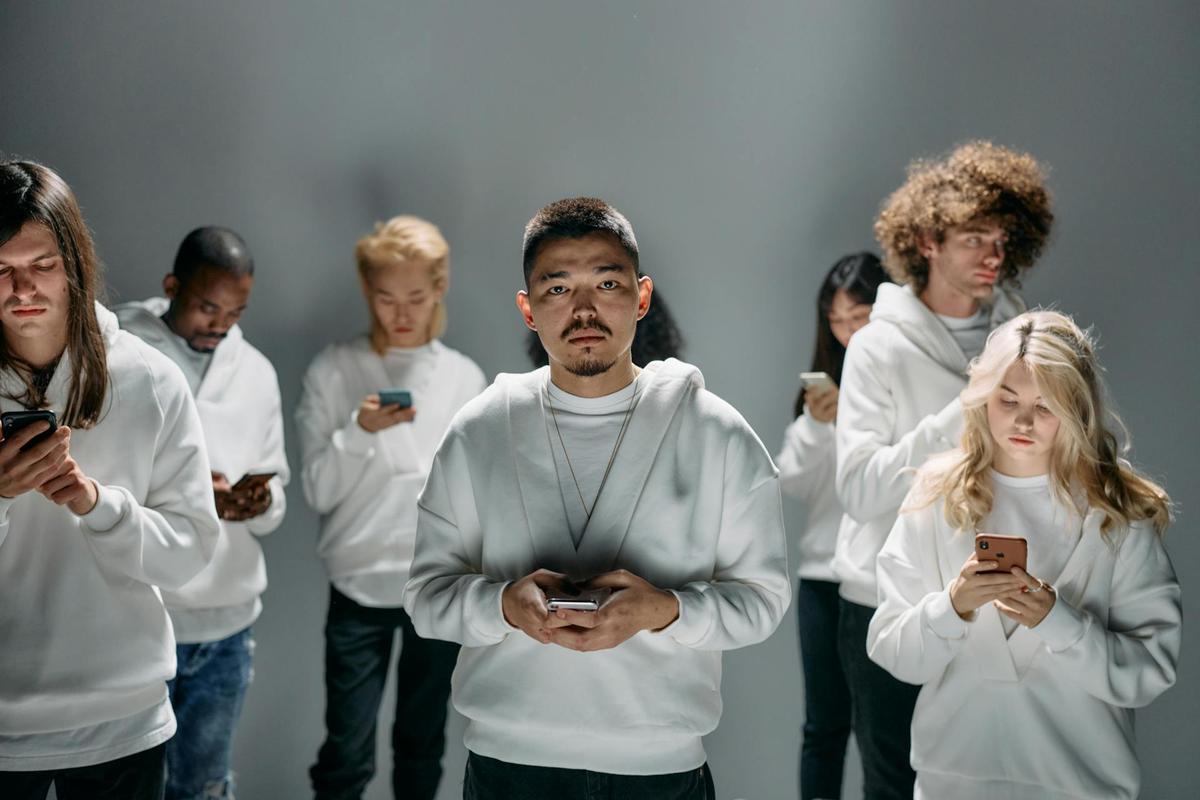 Diverse Gen Z young adults using smartphones in isolated spaces, illustrating digital connectivity and mental health challenges