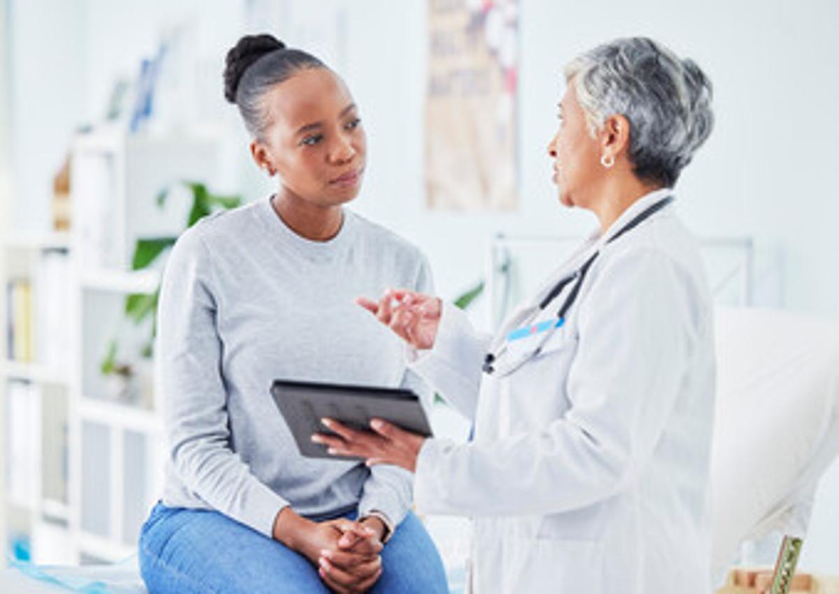 Patient consulting with doctor in white coat, representing the medical supervision required for Suboxone treatment and opioid use disorder recovery