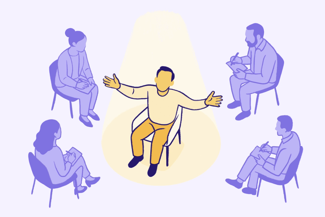 Person-centered therapy group session illustration with the client speaking openly while therapists take notes in a supportive mental health setting.