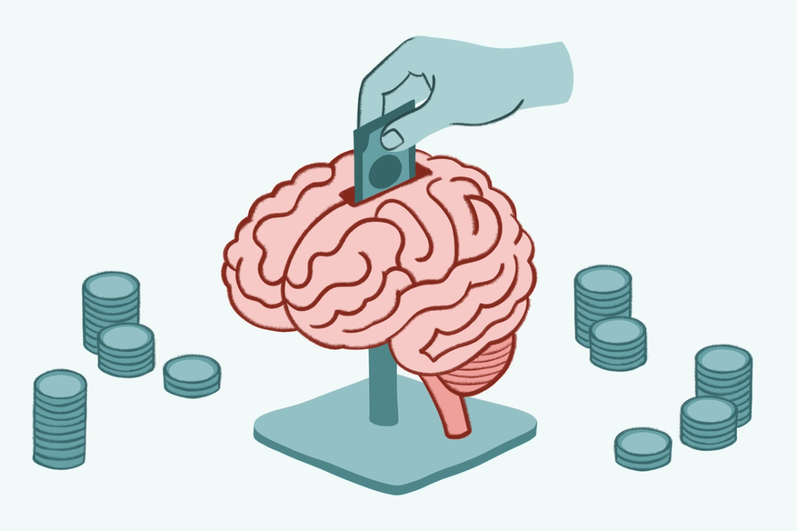 An illustration of a human brain functioning as a piggy bank, with a hand inserting a coin into a slot at the top and stacks of coins surrounding it