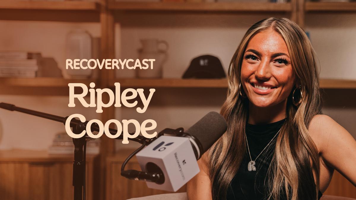 Recoverycast podcast episode featuring Ripley Coope seated at a microphone in a warm-toned studio. Ripley smiles toward the camera while sitting in front of a podcast microphone with Recovery.com branding.