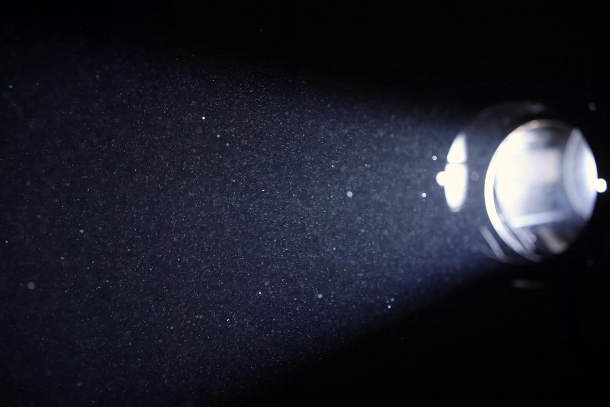 Aerosol spray can releasing chemical particles into air, illustrating the type of household product commonly misused as an inhalant