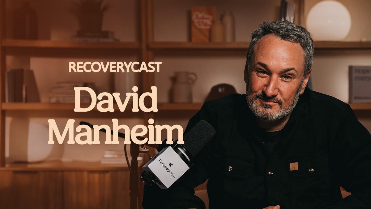 Recoverycast podcast guest David Manheim speaking into a microphone, sharing his sobriety story and insights on substance use recovery.