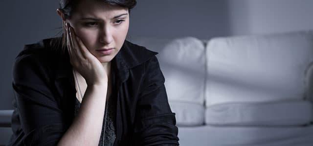 Woman experiencing grief and emotional distress, illustrating the connection between grief and addiction risk