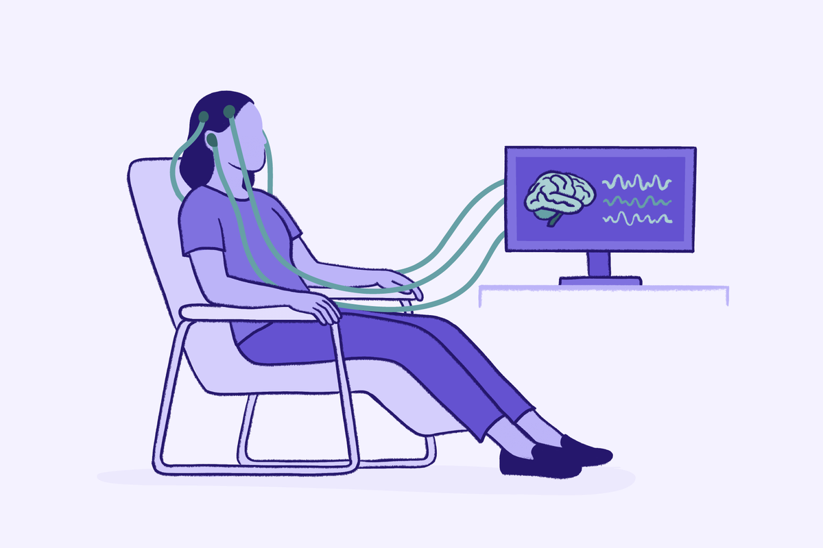 Person sitting in chair during neurofeedback therapy with sensors attached to head connected to monitor displaying brain activity waves.