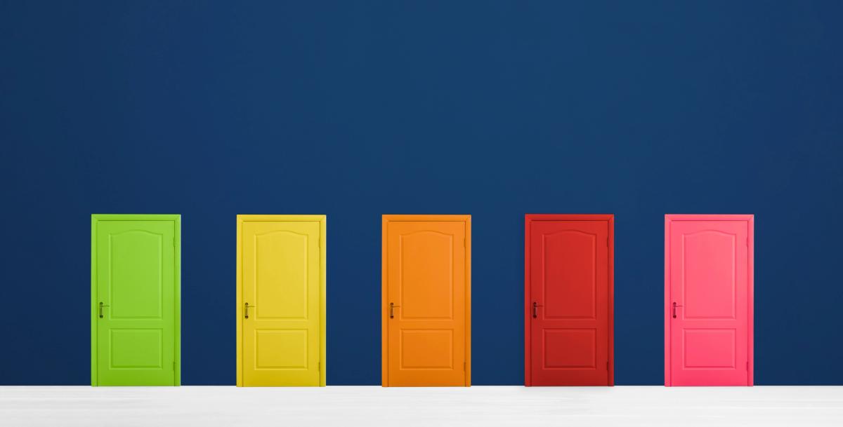 Row of brightly colored doors in green, yellow, orange, red, and pink representing diverse recovery paths