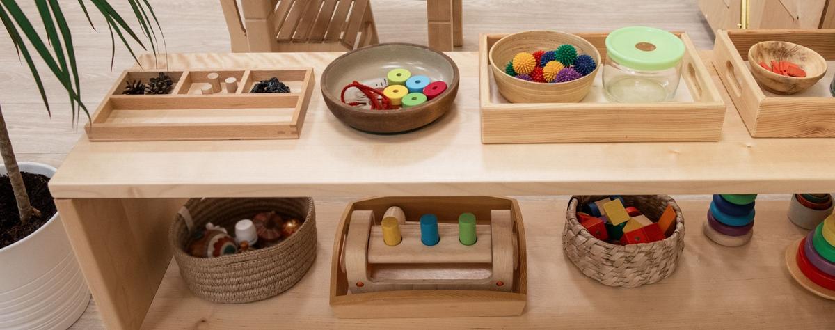 Organized sensory therapy materials including tactile balls, threading tools, and wooden blocks in a calming treatment space
