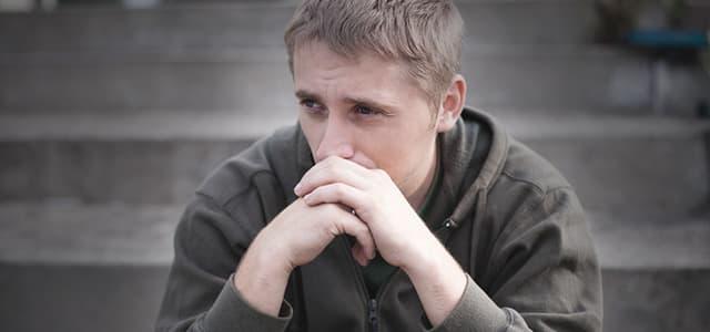 Young person looking worried and contemplative, struggling with carisoprodol addiction and considering treatment options