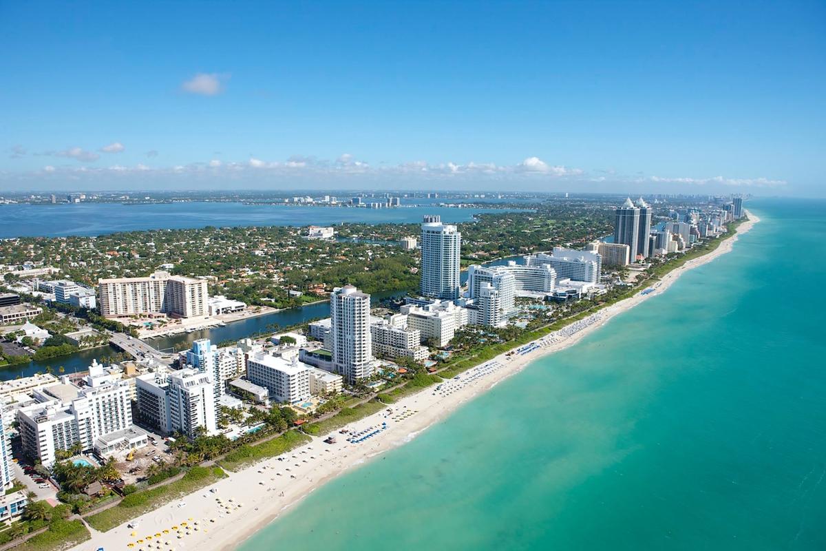 Aerial view of Miami Beach coastline with turquoise waters and white sand, showing the tropical setting for luxury rehab centers in South Florida
